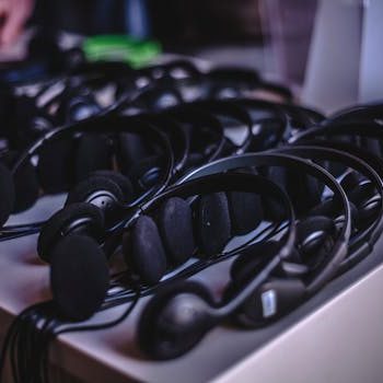 A variety of modern audio headsets neatly arranged on a display table indoors.